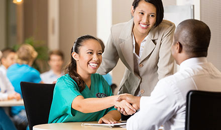 Caregiver shaking a man's hand